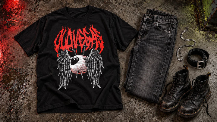 OLD VEGAS Dead Eyes graphic tee styled with charcoal jeans, black boots, a belt and a silver chain on dark concrete.
