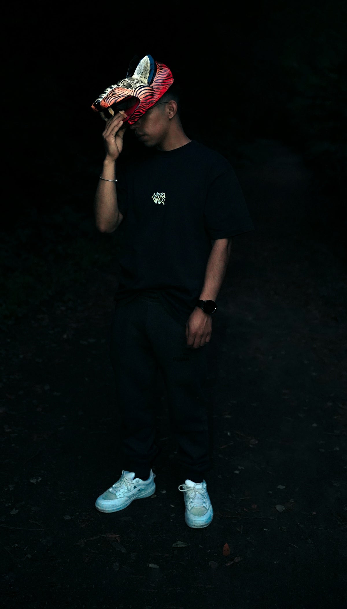 Man wearing a fox mask in dark setting