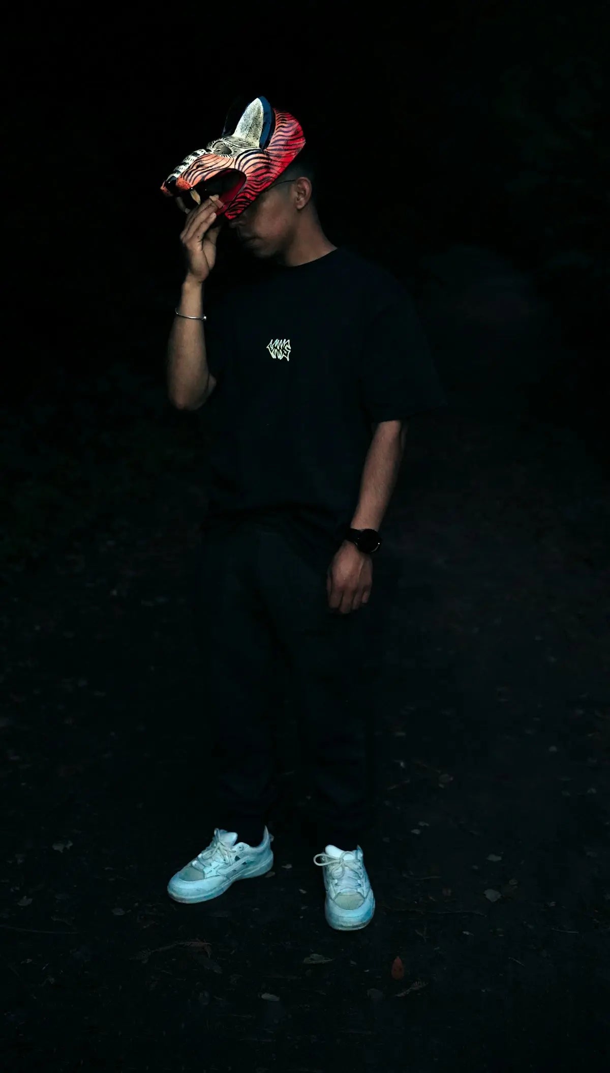 Man wearing a fox mask in dark setting