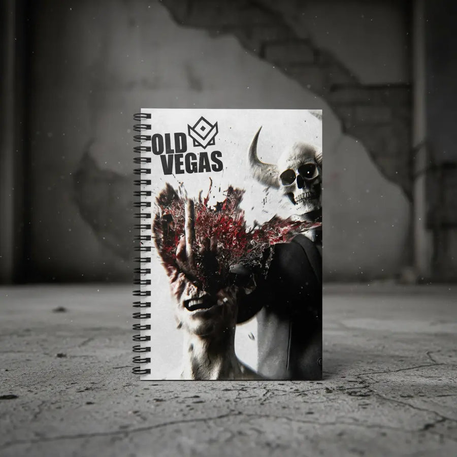 Black and white spiral-bound ruled notebook with old Vegas branding featuring a zombie face and skull cover design