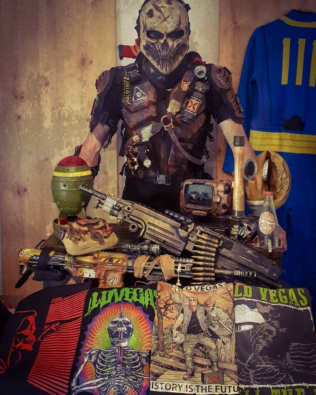 Fallout Essentials display: masked survivor in rugged armor with weapons and post-apocalyptic tees.