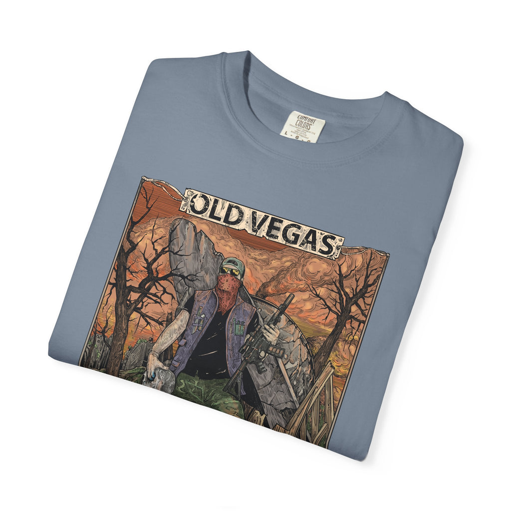 A folded light blue cotton crewneck t-shirt with a rugged figure graphic in warm old vegas desert tones