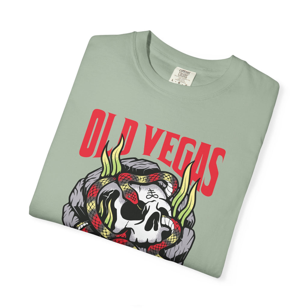 A folded light green cotton t-shirt with a bold red old vegas graphic and skull snake flames design