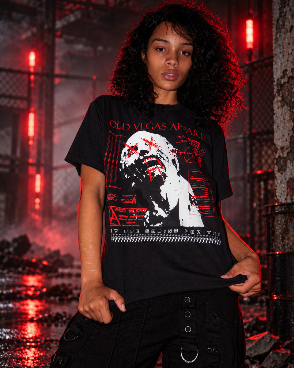 OLD VEGAS Zombie Red Alert black graphic tee on model in red-lit post-apocalyptic setting
